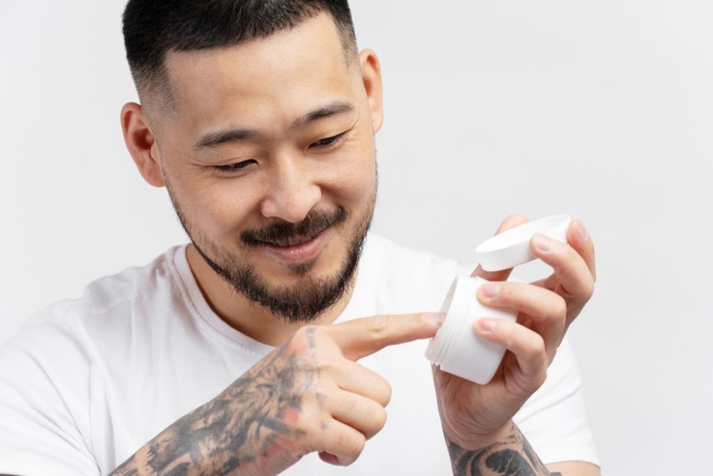 Man Applying Tattoo Numbing Cream.jpg