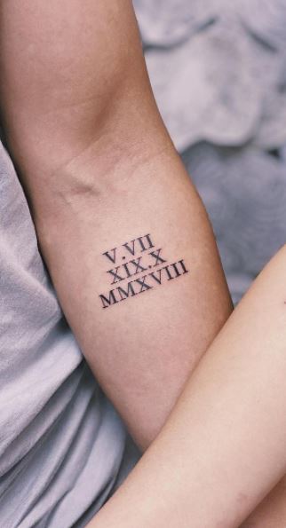 roman numeral arm tattoo for men