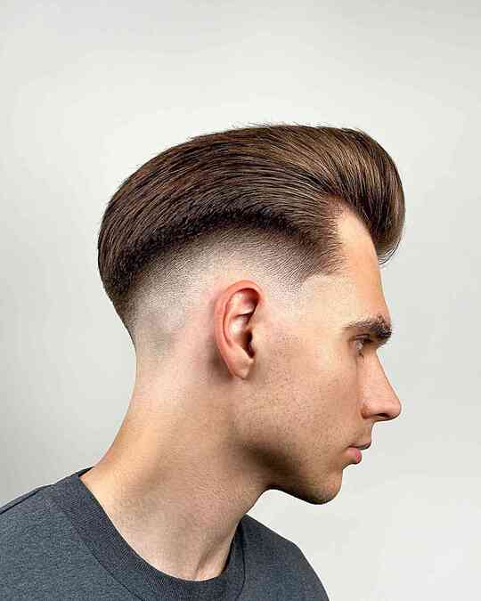 slicked up pomp with mid fade for men